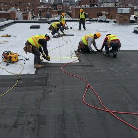 The Alter Phase Roofing Contracting crew installing a flat roof in Brooklyn